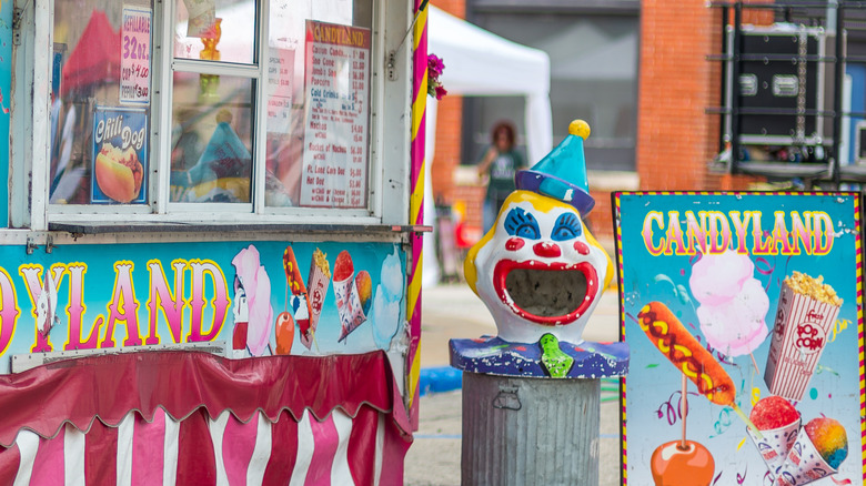 Food concession stand with clown and sign