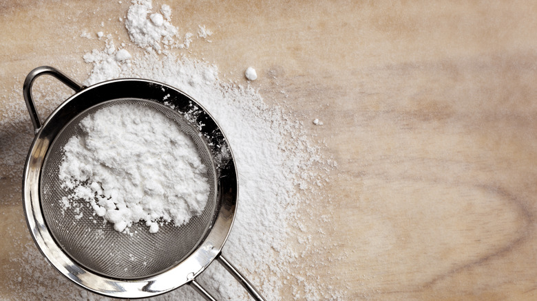 Powdered sugar in small colander