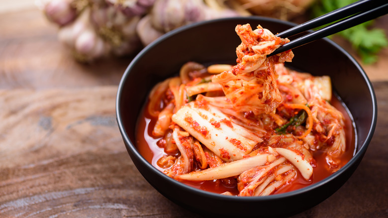 Kimchi in a bowl with chopsticks