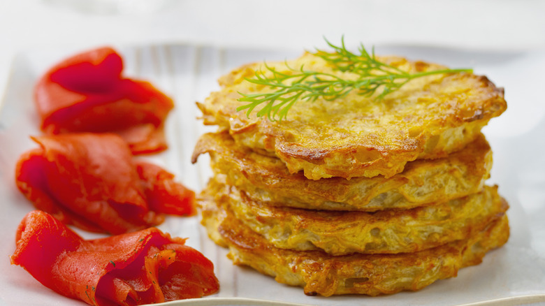 latkes stacked next to lox topped with dill