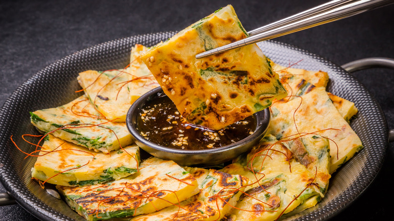 Chinese pancakes dipping into sauce