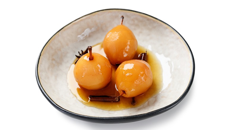 Poached pears in white bowl