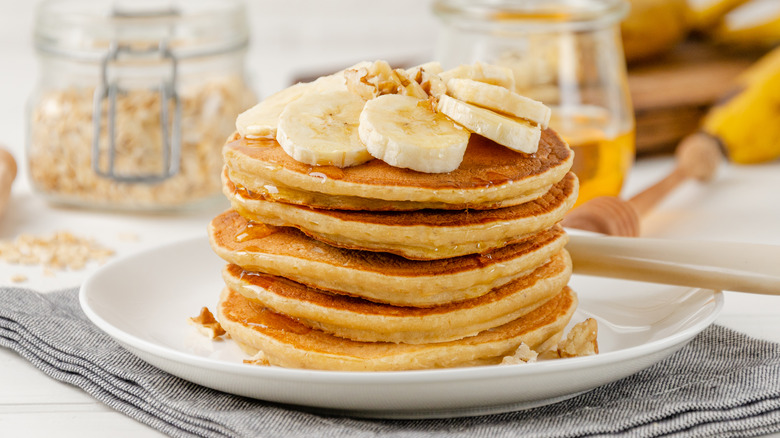 stack of pancakes topped with sliced bananas