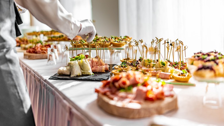 Person setting up buffet