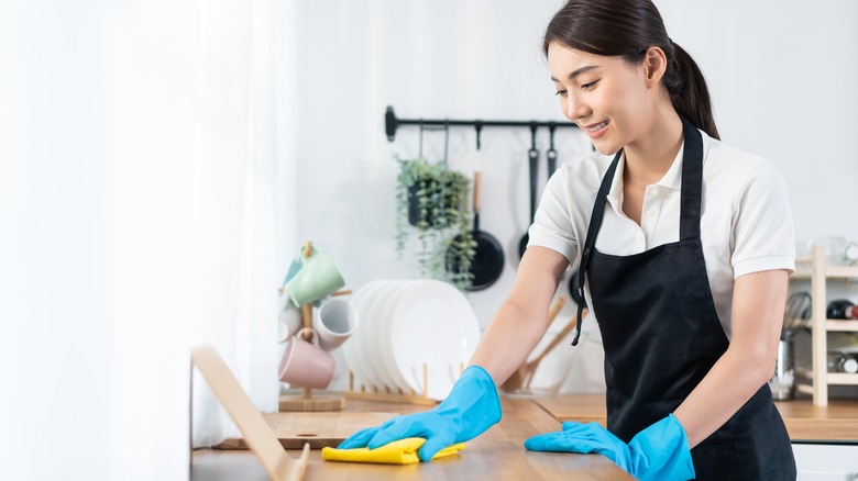 Woman wiping down her kitchen