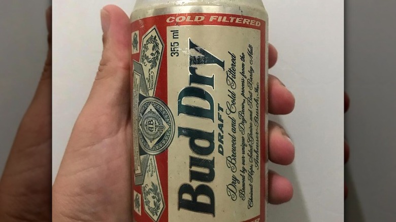 Hand holding Bud Dry can