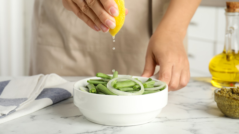 Squeezing lemon over food