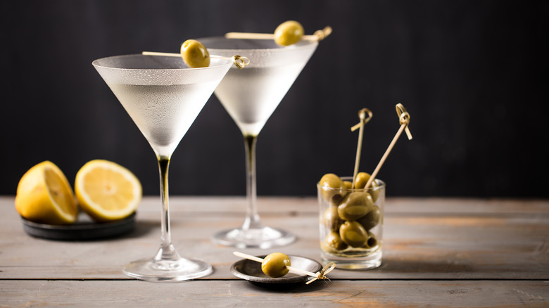 Two martinis with garnishes