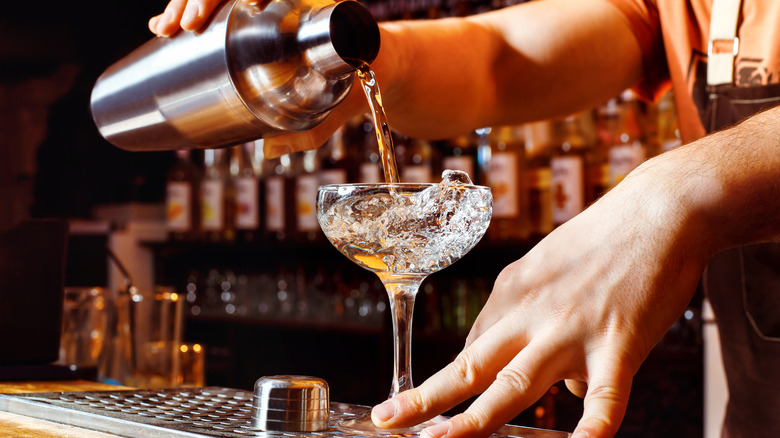 Bartender pouring a martini