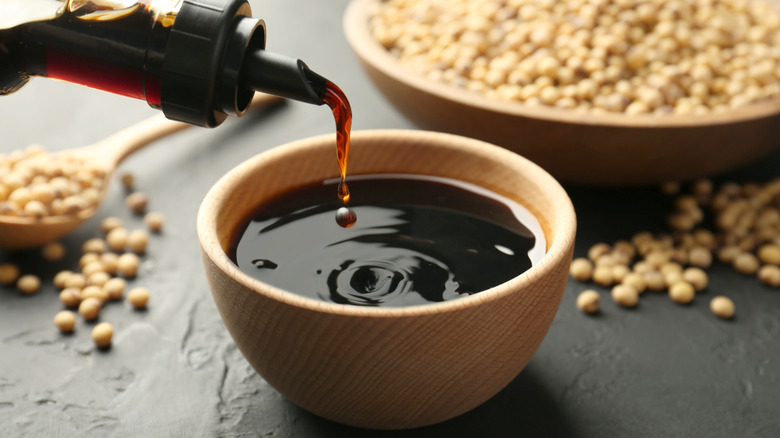 pouring soy sauce into bowl