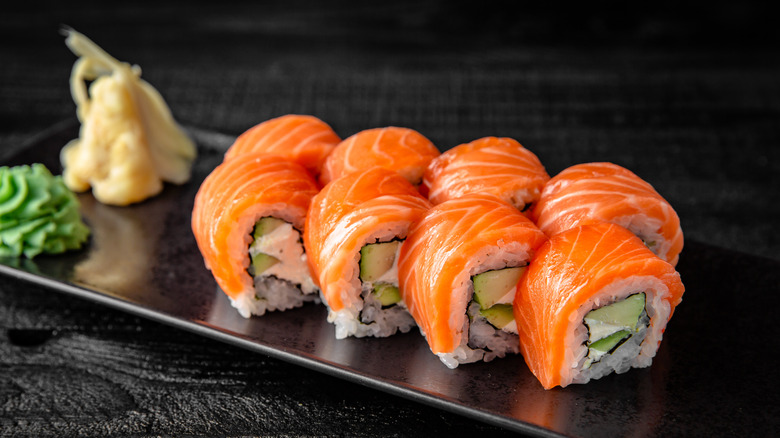 salmon covered sushi roll