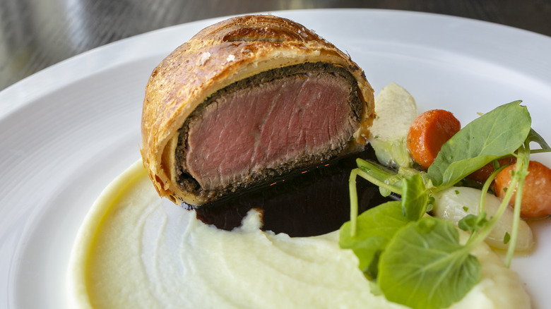 Beef Wellington with salad and sauce