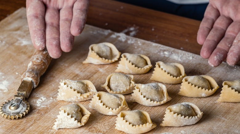 Handmade ravioli on wooden board