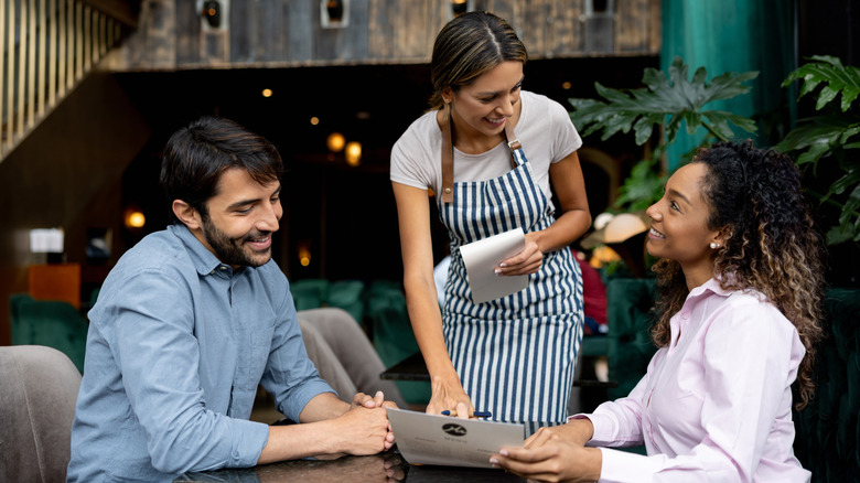 Couple ordering at restaurant