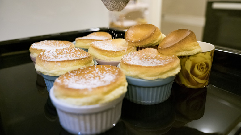 Soufflés being prepared in ramekins