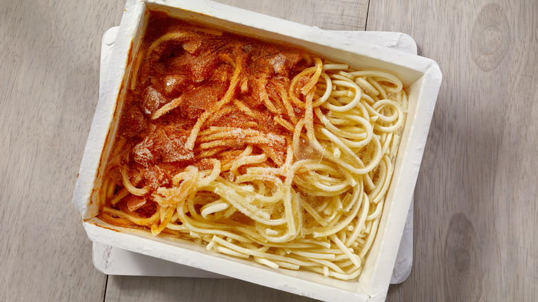 spaghetti in white paper tray