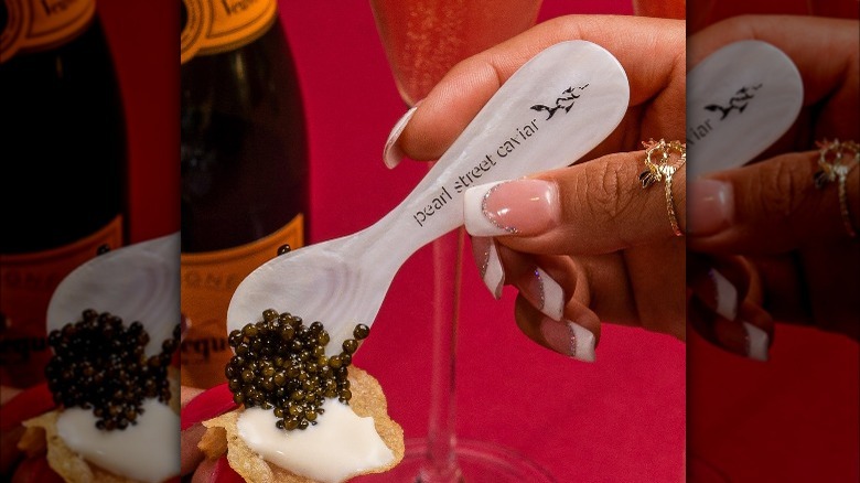 Caviar being placed on crispbread