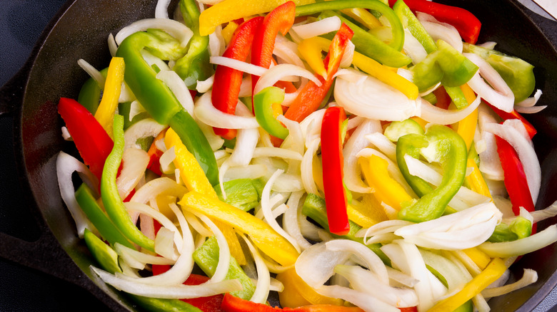 vegetables being sautéed in pan