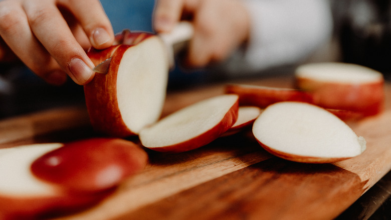 Person slicing apples