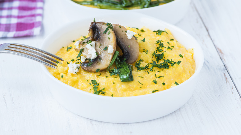 Grits with herbs in bowl