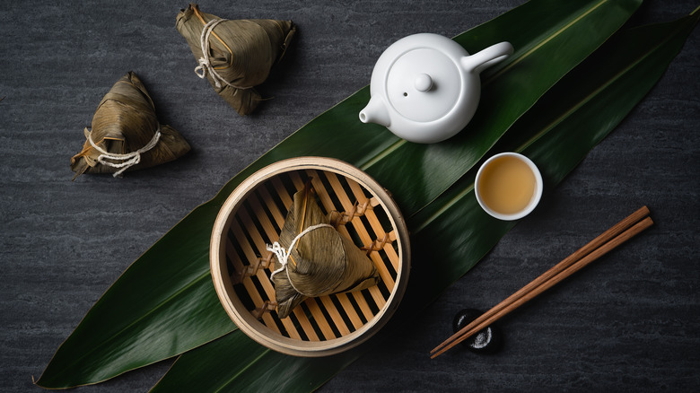 A bamboo steamer and wrapped zongzi