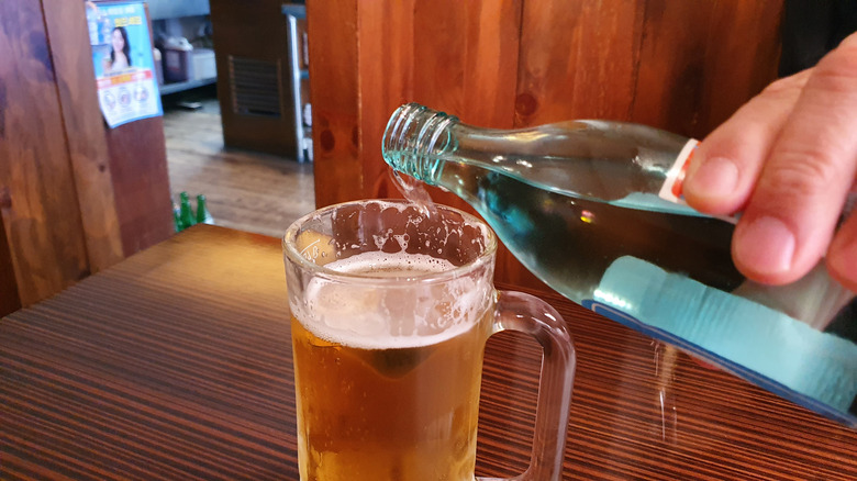 Pouring soju into beer mug