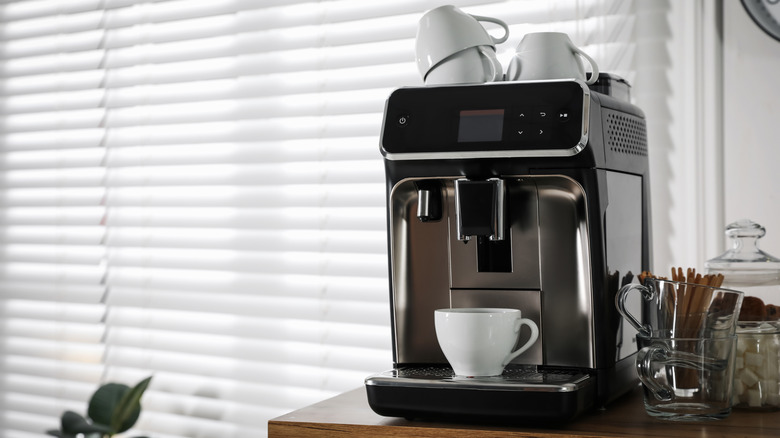 modern coffee maker with cup