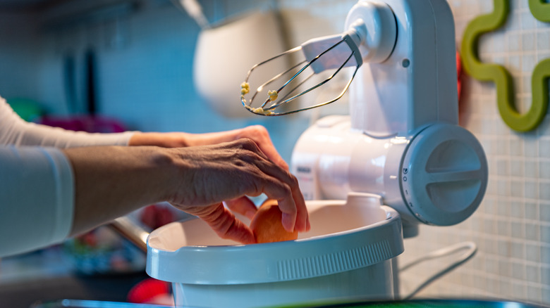 cracking egg into stand mixer