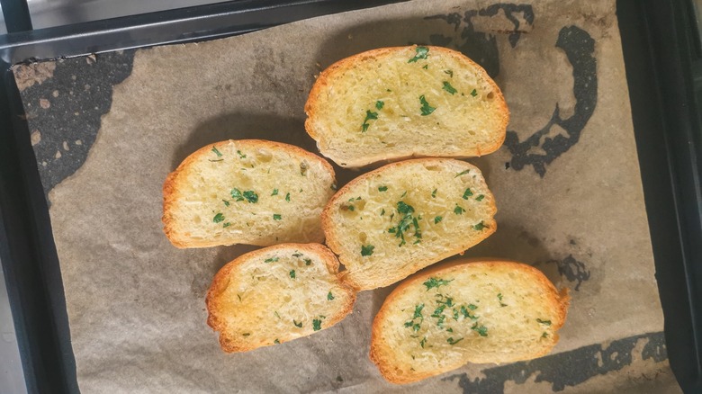 Garlic bread on baking sheet