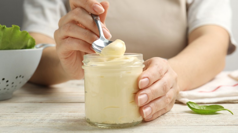 Person scooping aioli with spoon