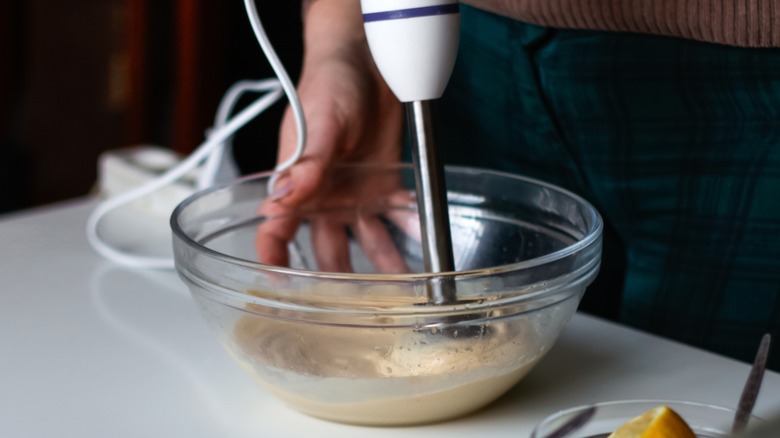 Person blending mixture in bowl