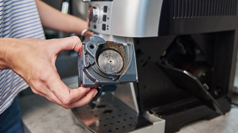 person taking apart an espresso machine for cleaning