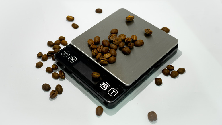 coffee beans spilling off of a digital scale