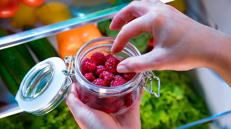 jar of raspberries in fridge