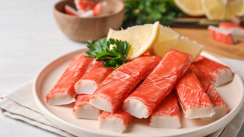 Crab sticks on plate with lemon