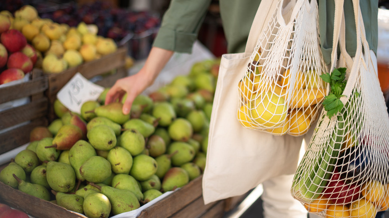 Person holding reusable bags