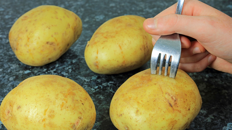 pricking potatoes with fork