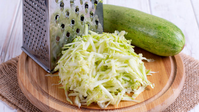 Grated zucchini on wood board