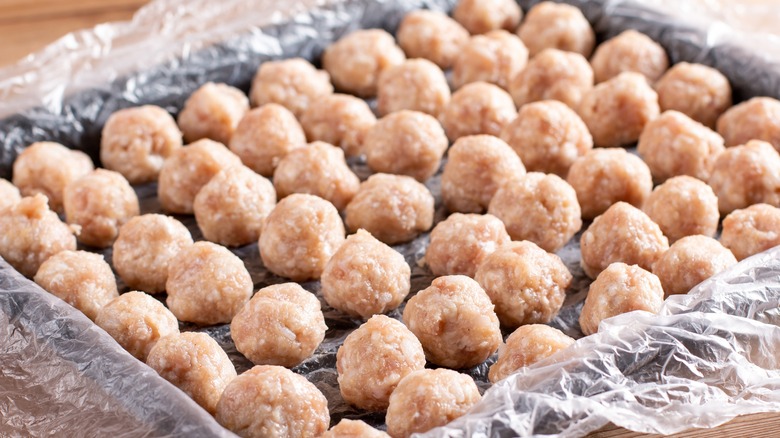 Frozen meatballs on baking sheet