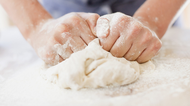 kneading a ball of dough