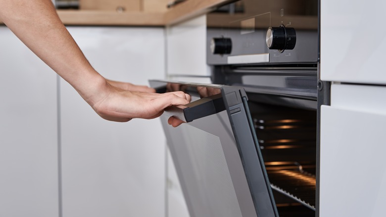 woman opening an oven door