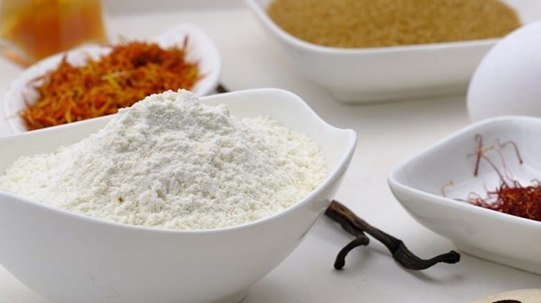 White bowls of flour and spices