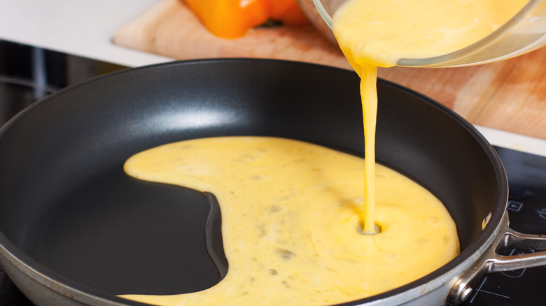 egg being poured into pan