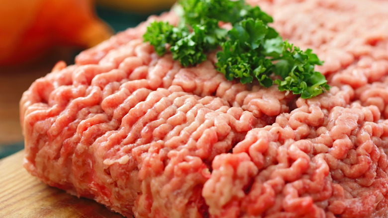 fresh ground beef on wooden board