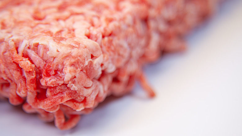 defrosting beef mince on white surface