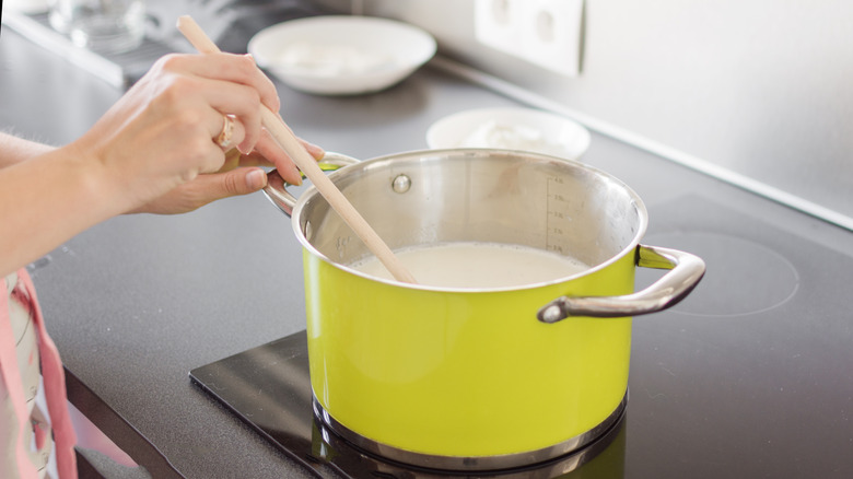 Person making béchamel sauce