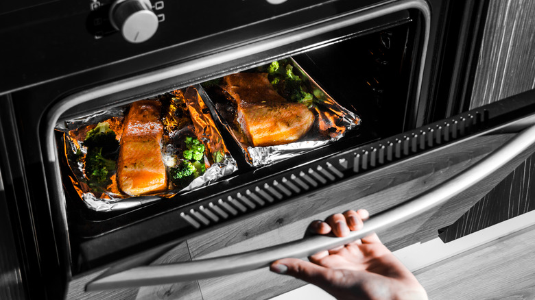 Person opening oven door