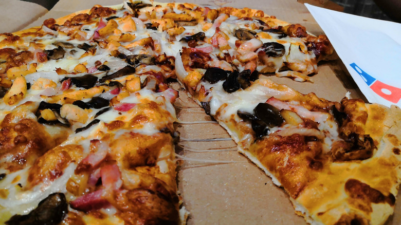 Slice of pizza on cardboard