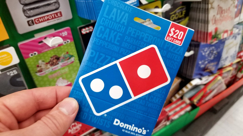 Person holding Domino's gift card