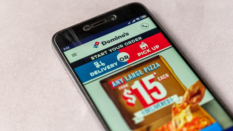 Holding phone with Domino's app